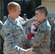 Airman 1st Class Phillip Stoops and Senior Airman Christopher Rodgers, both from the 48th Intelligence Squadron, greet each other after Airman Rodgers returned from a six-month deployment April 8. The deployment was the first deployment for image processors. (Air Force photo by Senior Airman Natalie Pittman)