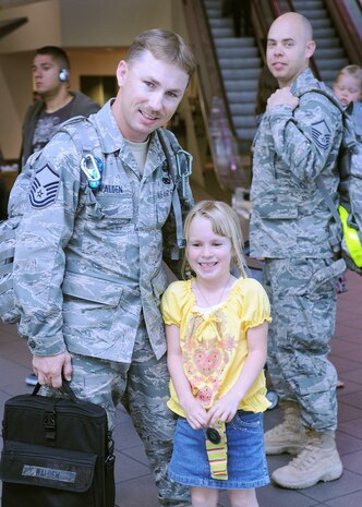 Master Sgt. Michael Walden, 48th Intelligence Squadron, greets his family after arriving at Sacramento International Airport April 8, after a Project Liberty Deployment. The eight 48 IS Airmen who deployed were the first image processors to deploy for Project Liberty. (Air Force photo by Airman 1st Class Krista Rose) 