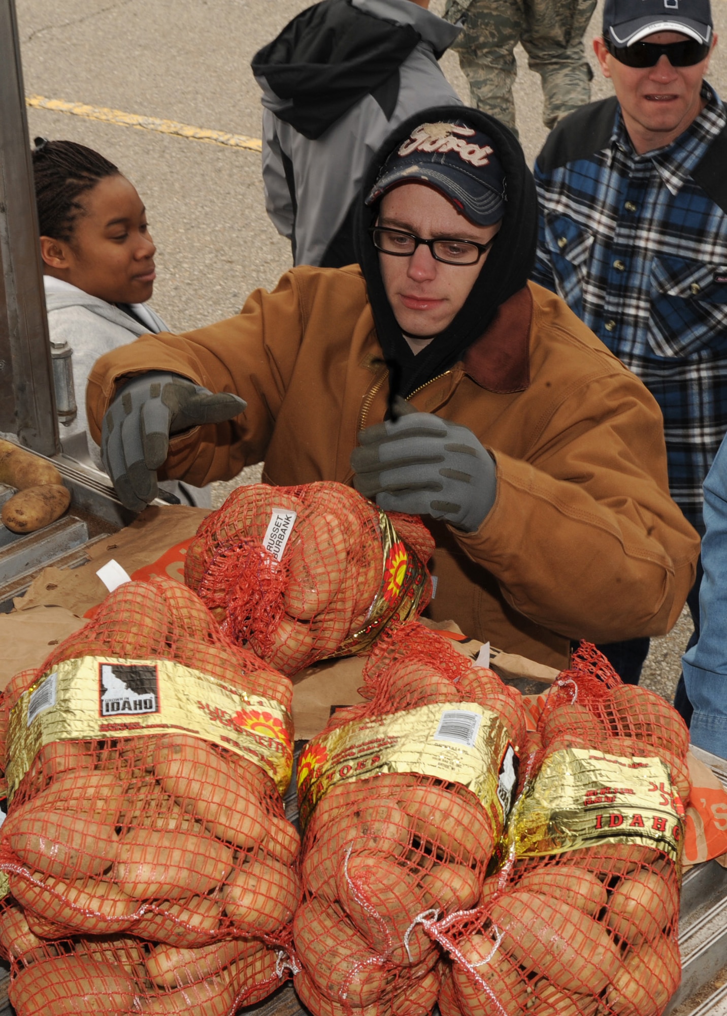 MOUNTAIN HOME AIR FORCE BASE, Idaho -- Airman Basic Christopher Dietz, 366th Logistic Readiness Squadron vehicle maintenance, helps unload potatoes outside the Base Exchange April 2. The event was sponsored by the Snake River Produce Company, Ucon and Idaho Falls farmer Lt. Col. Tom Holm (Ret) of Sun Valley and his wife Beverly. The Sun Valley Charitable Foundation gave away 35,000 pounds of potatoes to military families at MHAFB. (U.S Air Force photo by Airman 1st Class Renishia Richardson)