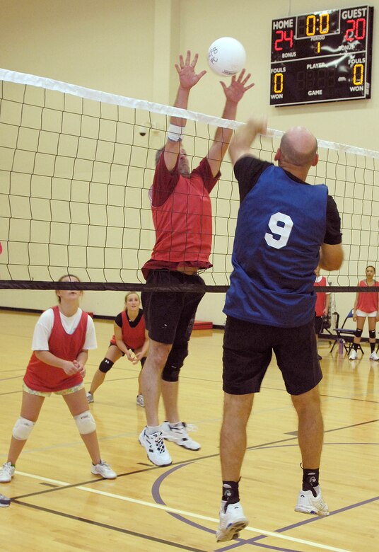 VANDENBERG AIR FORCE BASE, Calif. -- Skillfully, Jeff Willhite, from the 18th Intelligence Squadron team, spikes the ball through the hands of a blocker to score the final point, ending the volleyball match here Wednesday, April 7, 2010. The 18th IS won the game 2-0 against the 30th FSS/MSG team. (U.S. Air Force photo/Airman 1st Class Andrew Lee) 
 
 
 