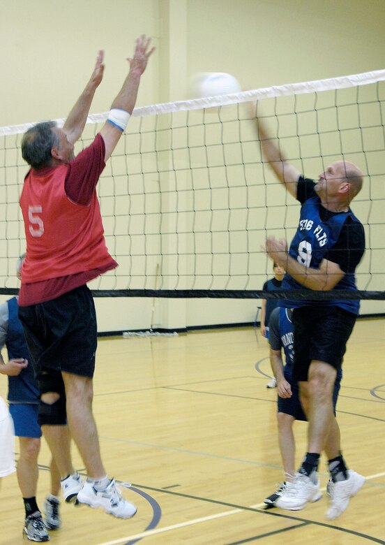 VANDENBERG AIR FORCE BASE, Calif. -- A player from the 30th Force Support Squadron/Mission Support Group team attempts to block a spike made by Jeff Willhite, from the 18th Intelligence Squadron team, during an intramural volleyball game here Wednesday, April 7, 2010. (U.S. Air Force photo/Airman 1st Class Andrew Lee) 
 
 