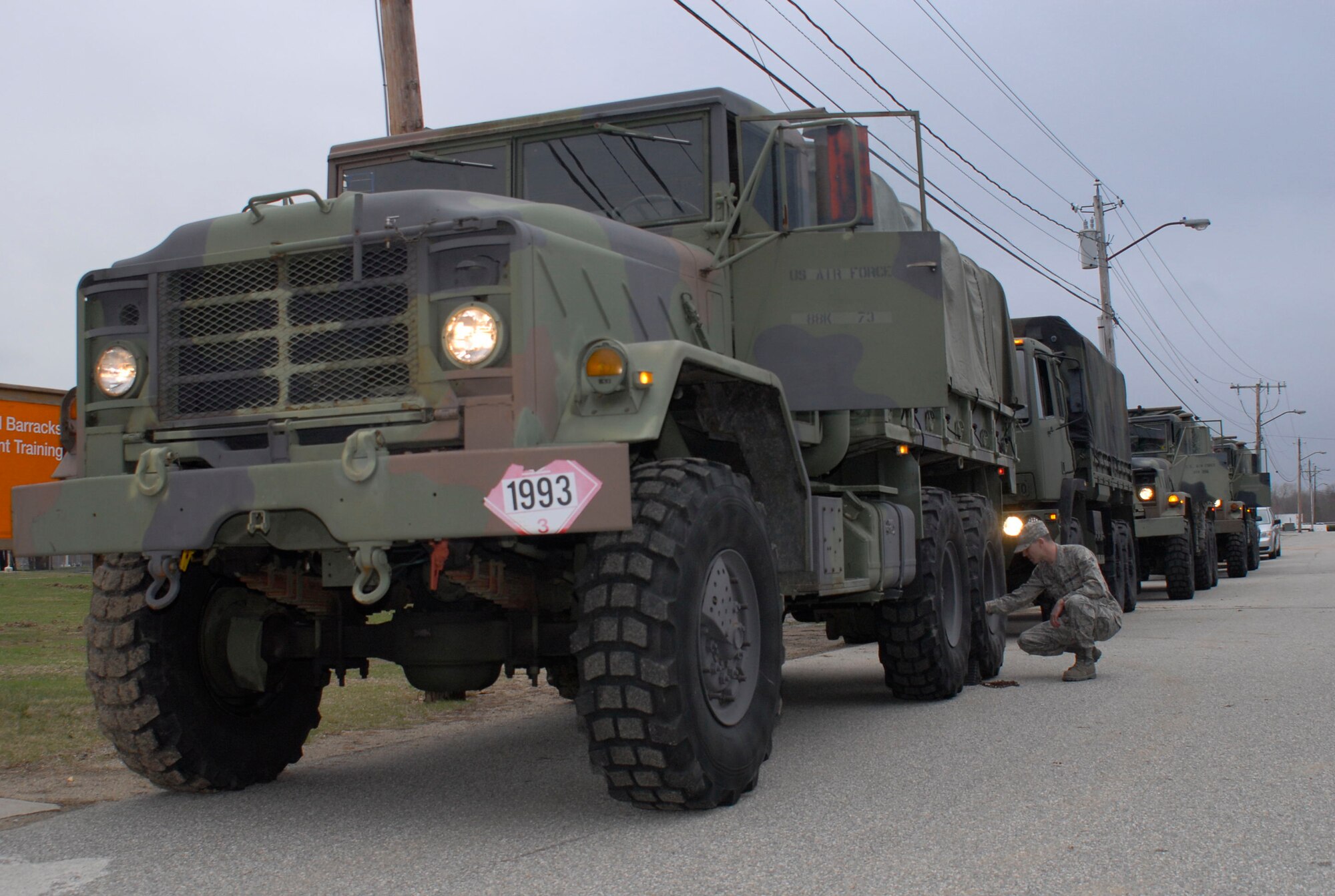 Senior Airman Christopher Devine inspects the wheel of his light medium tactical vehicle as the 103rd Air Control Squadron prepares to convoy back to Orange, Conn. after remaining on alert status at Camp Rell, Niantic, Conn. in support of flood relief March 31, 2010. Part of the 103rd Task Force, Devine’s mission capability included using the LMTVs to rescue people trapped because of high waters. (U.S. Air Force photo by Tech. Sgt. Joshua Mead)