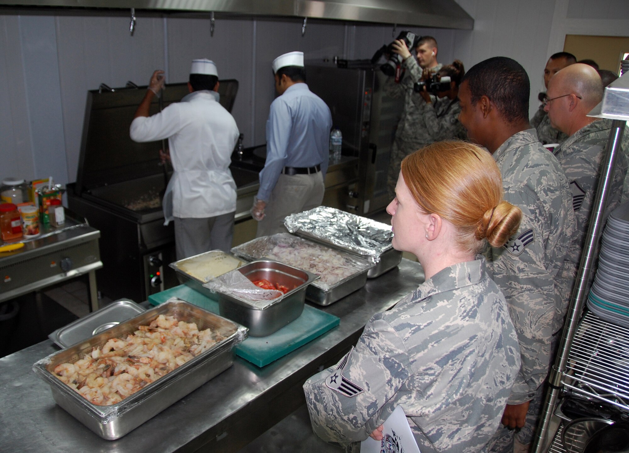 Members of the 387th Air Expeditionary Group watch as the Falcon Cafe staff prepares their favorite Indian food menu items April 6, 2010, during a cooking class at an air base in Southwest Asia. (U.S. Air Force photo/Tech. Sgt. Lindsey Maurice)