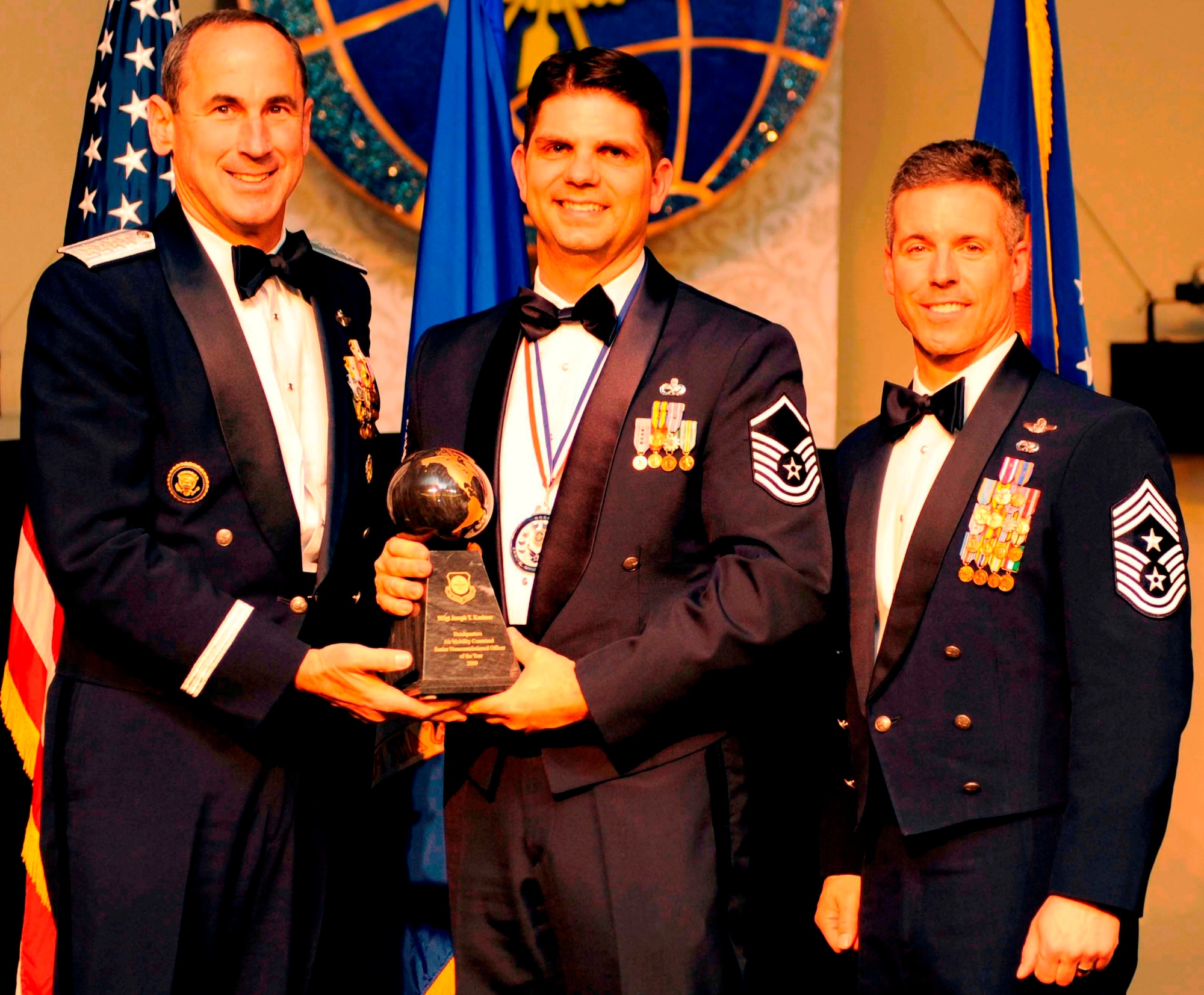 Master Sgt. Joseph T. Kazimer, of the U.S. Air Force Expeditionary Center, Joint Base McGuire-Dix-Lakehurst, N.J., is awarded 2009 Air Mobility Command Airman of the Year by AMC Commander, Raymond E. Johns, and AMC's Command Chief, Chief Master Sgt. David Spector at an award ceremony at Scott Club on Scott Air Force Base, Ill. 