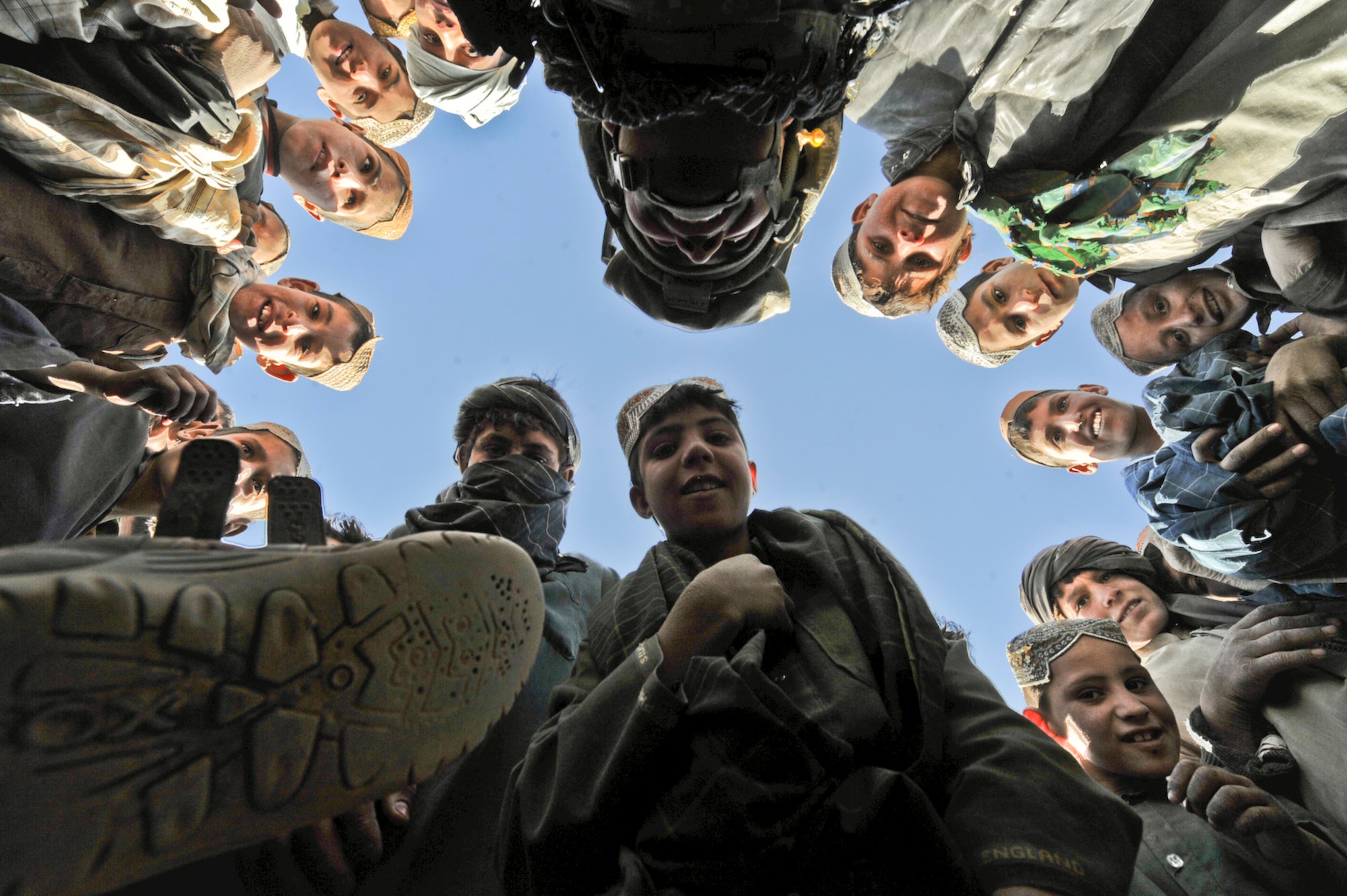 Tech. Sgt. Efren Lopez plays with Afghan children during a medical capabilities operation Nov. 18, 2009, in Zakuzi Village, Zabul province, Afghanistan. MEDCAPs provide medical treatment to local Afghans as part of Operation Enduring Freedom. Sergeant Lopez is a photographer with 4th Combat Camera Squadron, March Air Reserve Base, Calif. (U.S. Air Force photo/Tech. Sgt. Efren Lopez)