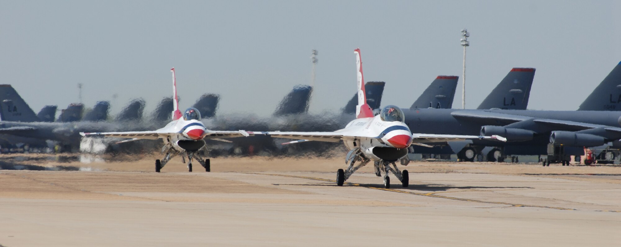 BARKSDALE AIR FORCE BASE, La. – Two F-16s from the Air Force demonstration team, the Thunderbirds, taxi past B-52s during the 2007 Defenders of Liberty Air Show. The Thunderbirds return this year to headline the 2010 Air Show here April 24 - 25. (U.S. Air Force photo by Senior Airman Joanna Kresge)