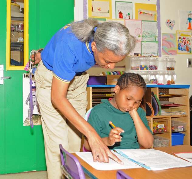 BARKSDALE AIR FORCE BASE, La. – Cora Davis, 2d Force Support Squadron, helps Jalaya Robinson, 8, daughter of Army Sergeant Danielle Jones, 318th Medical Group, with assigned homework as she waits for her mother to pick her up from the Barksdale Youth Center. The youth center offers an after-school program to keep children in a safe and secure environment until their parents are able to pick them up after work hours. (U.S. Air Force photo by Senior Airman Alexandra M. Longfellow) (RELEASED)