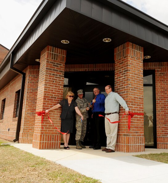 MOODY AIR FORCE BASE, Ga. -- Diana Burns, Housing Capital asset manager, Col. William DeMaso, 23rd Wing vice commander, Brian Doak, U.S. Army Corp of Engineers project engineer, and Stuart Robinette, construction worker, cut a ribbon here April 8 to celebrate the completion of a new base dormitory. The new dorm took approximately 16 months to complete. (U.S. Air Force photo by Airman Class Joshua Green) 