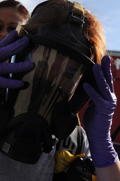 MOODY AIR FORCE BASE, Ga. -- Senior Airman Sarah Cox, 23rd Aeromedical Dental Squadron bioenvironmental journeyman, removes her oxygen mask after conducting a training scenario during the Air Combat Command Chemical, Biological, Radiological and Nuclear Challenge here April 7. Airman Cox was the team lead in an all-hazards response scenario. (U.S. Air Force photo by Airman 1st Class Benjamin Wiseman/RELEASED)