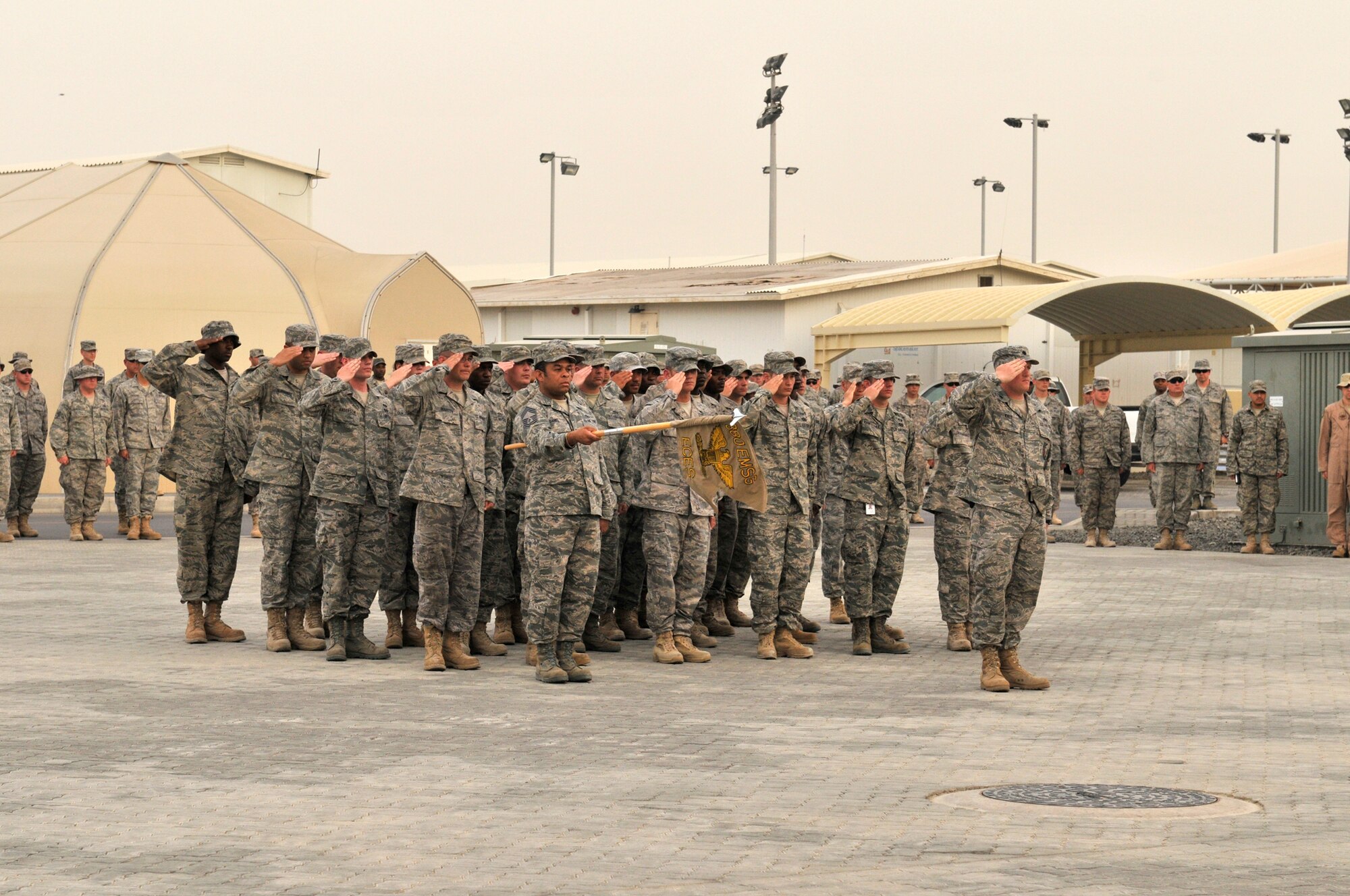 Lt. Col. William Kale III, 380th Expeditionary Civil Engineering Squadron Commander, takes the lead for this CE formation April 9 at an undisclosed location in Southwest Asia. The 380th Air Expeditionary Wing brings together active duty, reserve and Air National Guard Airmen joined with civilian patriots and DoD contractors to carry out its diverse mission of all-weather high-altitude ISR, airborne command and control and air refueling with a "One Team, One Fight" attitude. (U.S. Air Force Photo/Capt. Cathleen Snow/Released)