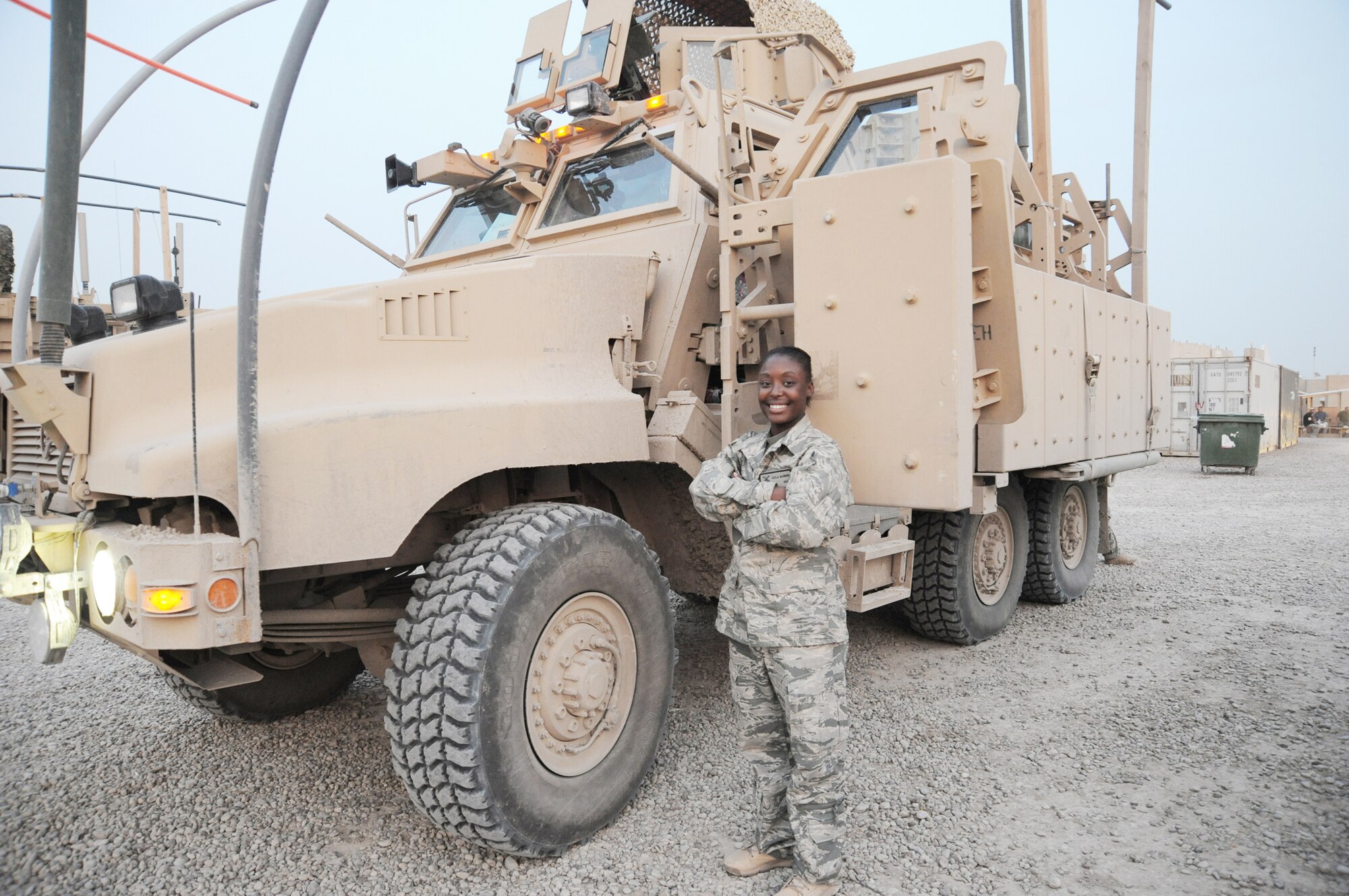 Senior Airman Kayla Manning stands in front of her mine-resistant, ambush-protected vehicle after returning from a mission April 4, 2010, at Camp Stryker, Iraq.  Airman Manning is from the 732nd Expeditionary Security Forces Squadron, Det. 2. (U.S. Air Force photo/Master Sgt. Trish Bunting) 