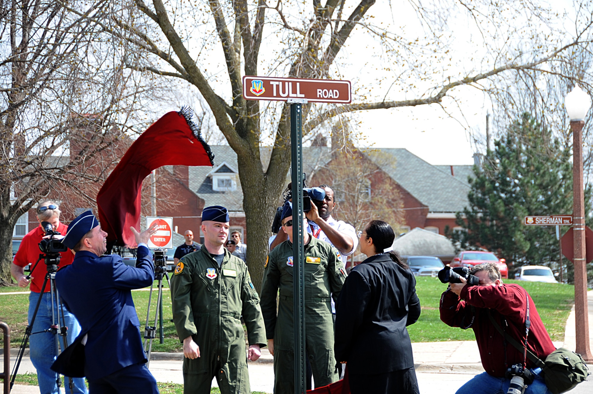 OFFUTT AIR FORCE BASE, Neb. -- 55th Wing Commander Brig. Gen. John N.T. Shanahan and Dr. Janet Tull, the daughter of retired Lt. Col. Harrison "Harry" Tull, a Tuskegee Airman during World War II and a former 55th Wing officer who recently passed away, unveil the road sign for the newly dedicated Tull Road here April 6. The road was named in honor of Colonel Tull, who served more than 27 years in the Air Force including combat tours in the Korean and Vietnam Wars. U.S. Air Force photo by Kendra Williams