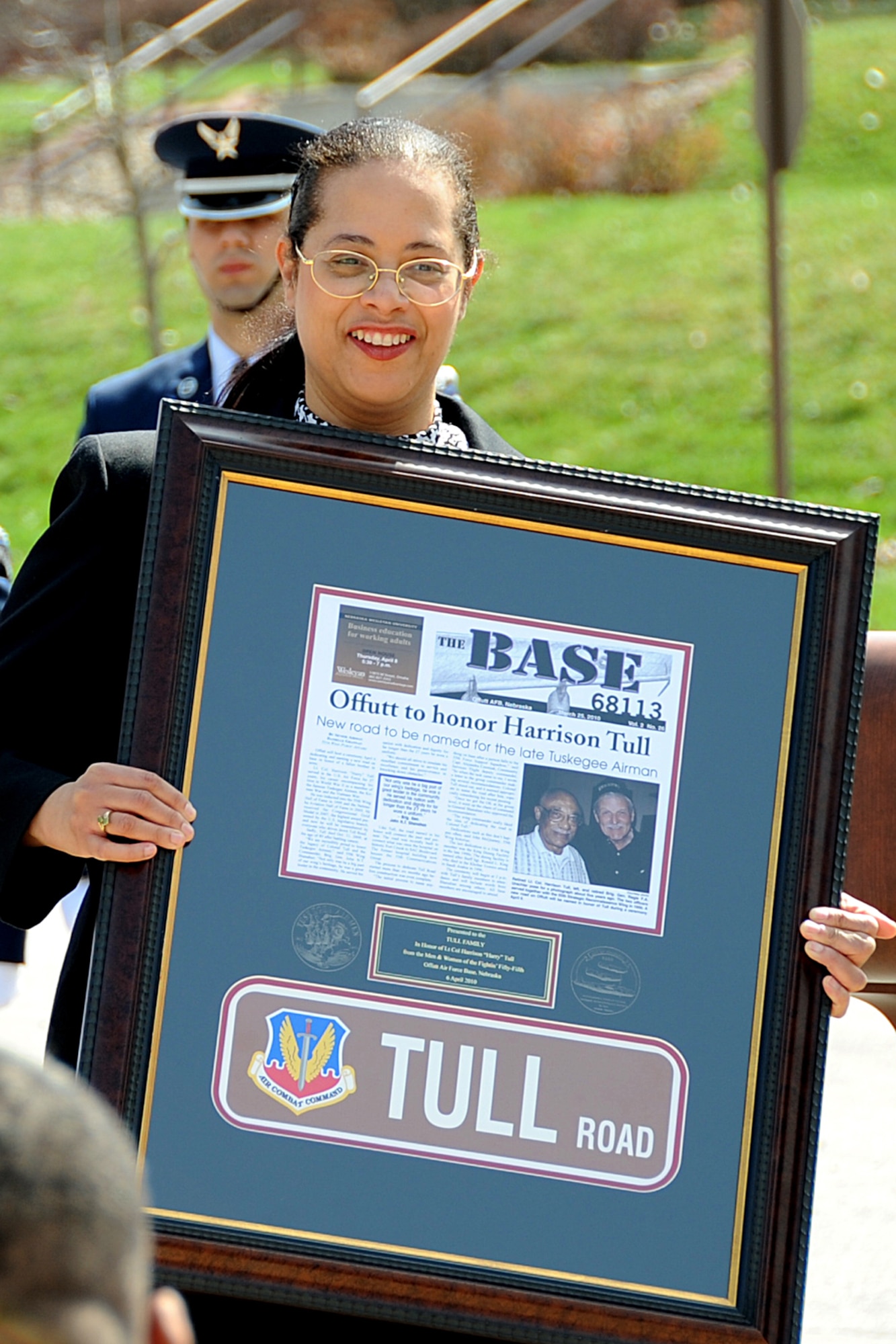 OFFUTT AIR FORCE BASE, Neb. -- Dr. Janet Tull, the daughter of retired Lt. Col. Harrison "Harry" Tull, a Tuskegee Airman during World War II and a former 55th Wing officer who recently passed away, holds a plaque commemorating the dedication of Tull Road, named in honor of her father here April 6. Colonel Tull served more than 27 years in the Air Force including combat tours in the Korean and Vietnam Wars. U.S. Air Force photo by Kendra Williams