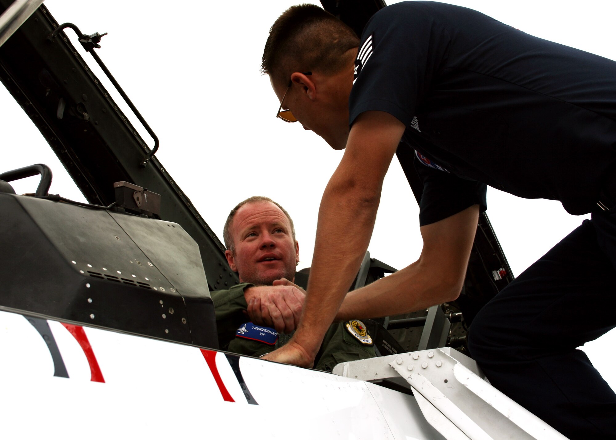 Jason Evans gets a "good-luck" handshake from a Thunderbirds maintainer April 8 prior to his incentive flight at Eglin Air Force Base, Fla.  Mr. Evans was selected as the "Hometown Hero" and received a ride in a Thunderbird F-16.  (U.S. Air Force photo/2nd Lt. Andrew Caulk.)