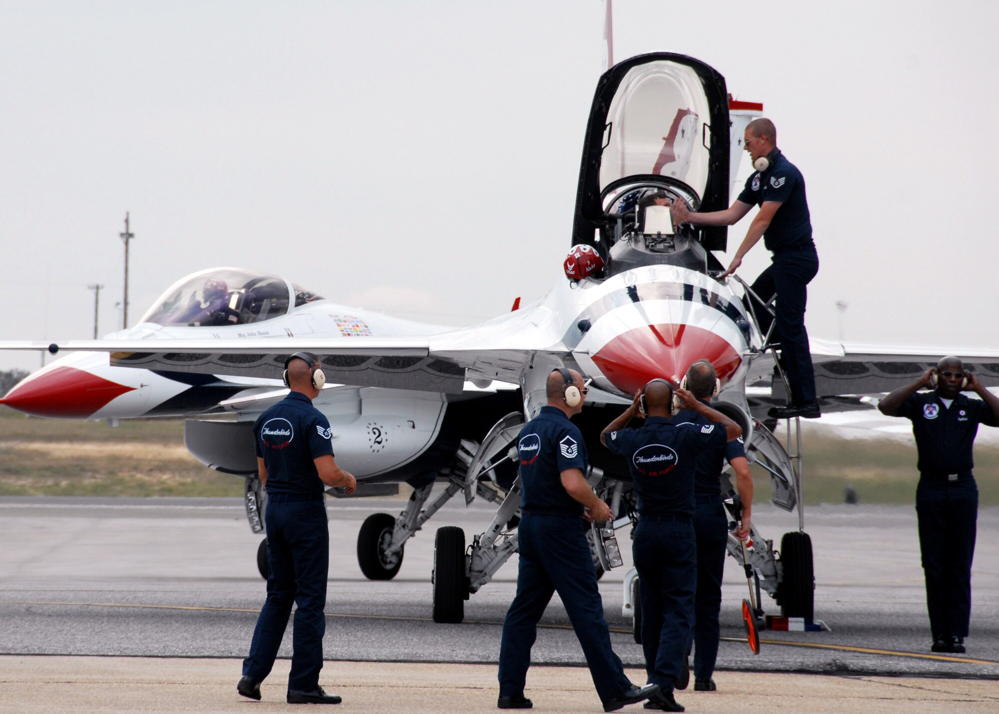 Thunderbird maintainers scurry around their F-16 while another taxis in at Eglin Air Force Base, Fla., April 8 in preparation for the airshow April 10 and 11.  The T-birds will perform both days with their ground show beginning at 3 p.m.  The airshow begins at 9 a.m. on both days.  See www.eglin.af.mil for more information.  (U.S. Air Force photo/Samuel King Jr.)
