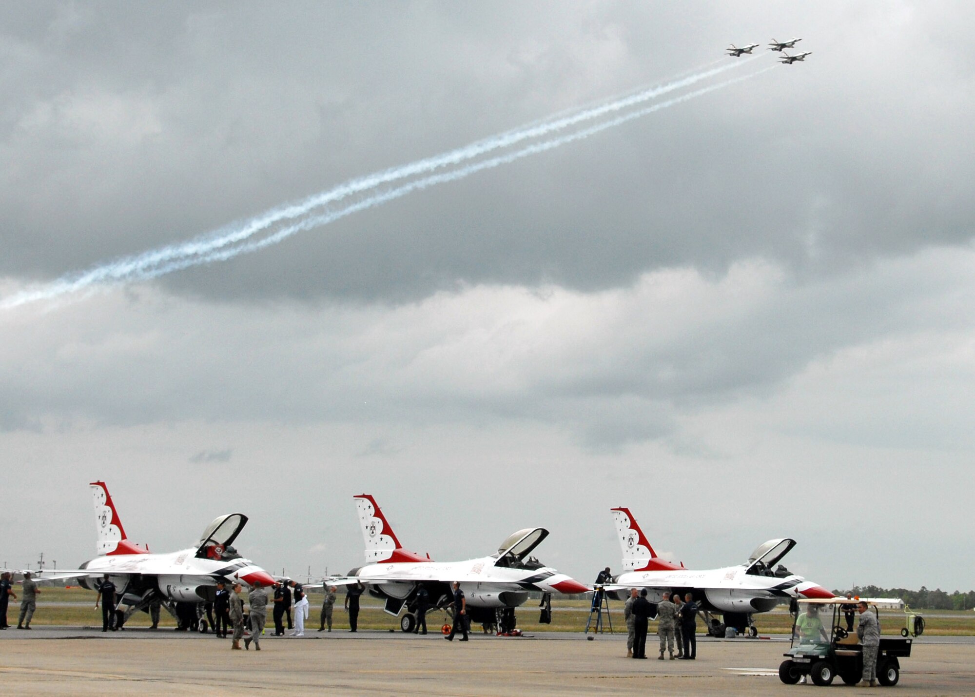 A formation of three Thunderbird F-16s soars over the skies of Eglin Air Force Base, Fla., April 8 while three others already sit on the flightline awaiting the airshow April 10 and 11.  The T-birds will perform both days with their ground show beginning at 3 p.m.  The airshow begins at 9 a.m. on both days.  See www.eglin.af.mil for more information.  (U.S. Air Force photo/Samuel King Jr.)