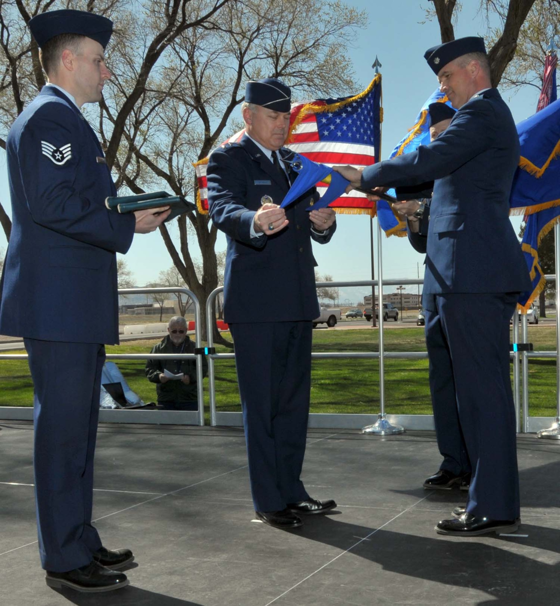 Maj. Gen. Stephen T. Sargeant, Air Force Operational Test and Evaluation Center Commander, furls the AFOTEC Detachment 3 flag with help from Lt. Col. Christopher A. Hawes, AFOTEC Det. 3 Commander, and SSgt. Justin Schoenthal during an April 5 inactivation ceremony at Kirtland Air Force Base, N.M.
