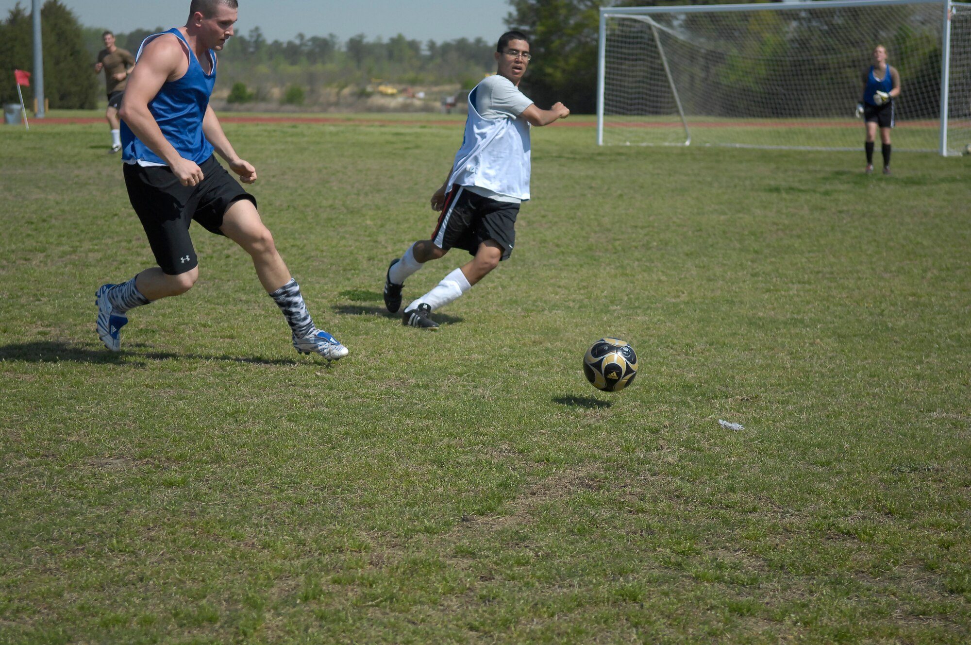 Airman 1st Class Deaven Randolph, 43rd Comptroller Squadron and Senior Airman Lee Ford, 43rd Aerial Port Squadron, race to take control of the ball during a soccer game April 6. The 43rd CPTS meet throughout the week to conduct PT.  (U.S. Air Force Photo/ 2nd Lt. Cammie Quinn)