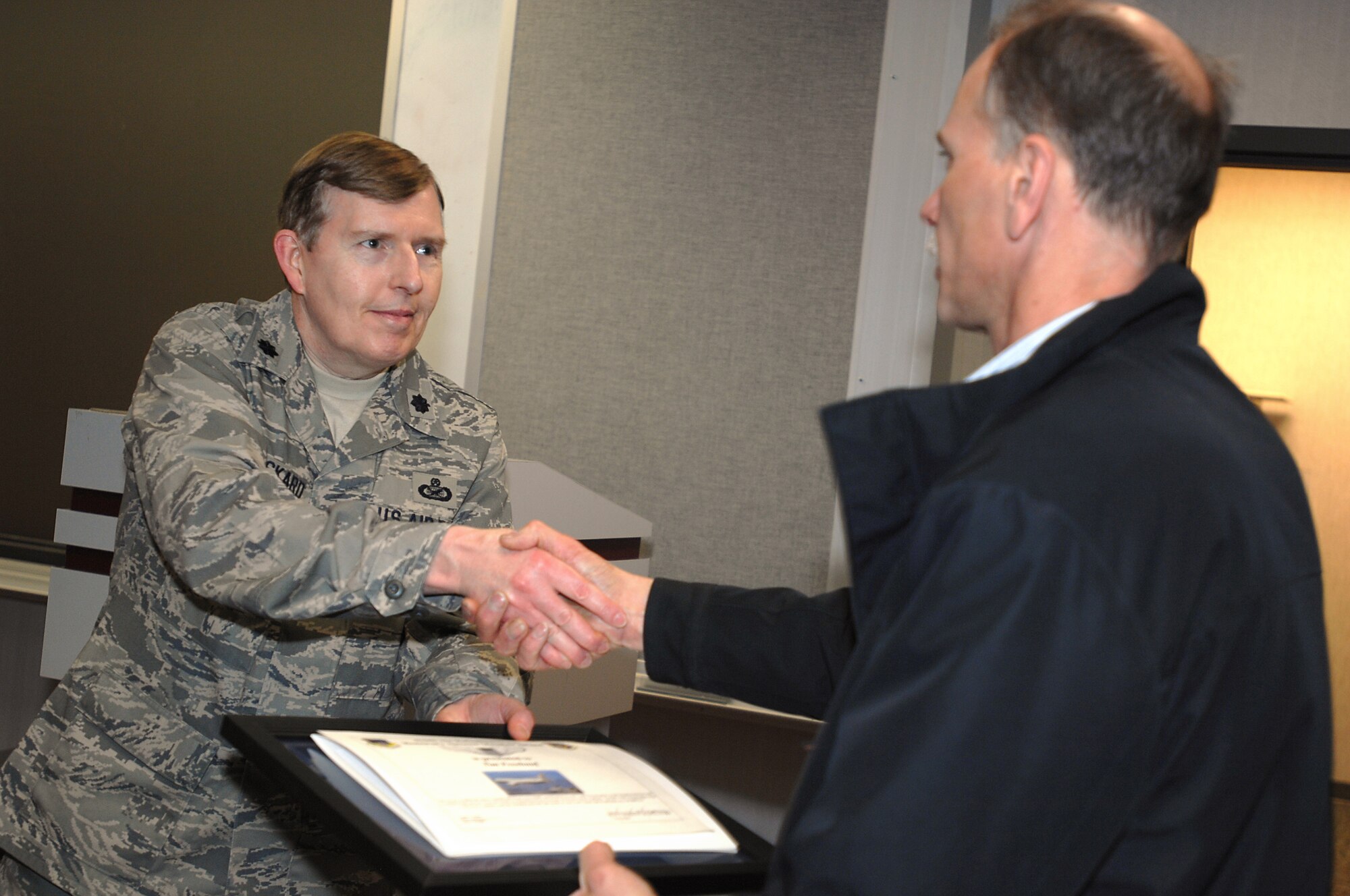 GRISSOM AIR RESERVE BASE, Ind., -- Lt. Col. Gary Lockard, 434th Air Refueling Wing public affairs chief, presents Tim Freehauf with a plaque from the Employer Support of the Guard and Reserve as well as an honorary aircrew certificate after an employer flight held here April 7. Mr. Freehauf, along with other employers of Grissom reservists visited the base to get a firsthand look at the 434th ARW as well as an aerial refueling mission. (U.S. Air Force photo/Tech. Sgt. Mark R. W. Orders-Woempner)