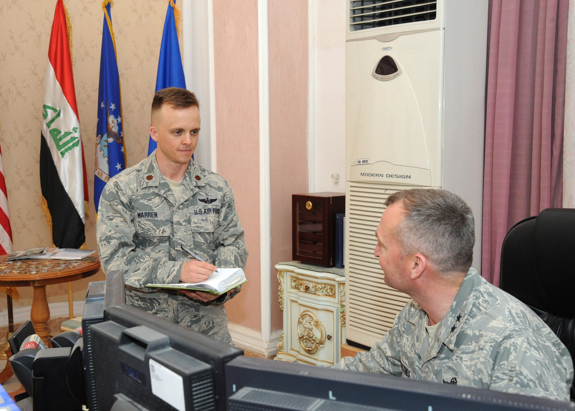 Air Force Maj. Britt Warren takes notes during a meeting with Maj. Gen. Joseph Reynes at the Air Force House, Camp Victory, Iraq, April 2, 2010. The mission of an executive officer is to take care of the details for whomever they are assigned to help.  They also handle the schedule and provide products such as meeting information, slides and documentation so that the general can focus on the bigger strategic picture. (U.S. Air Force photo/Master Sgt. Trish Bunting/Released)