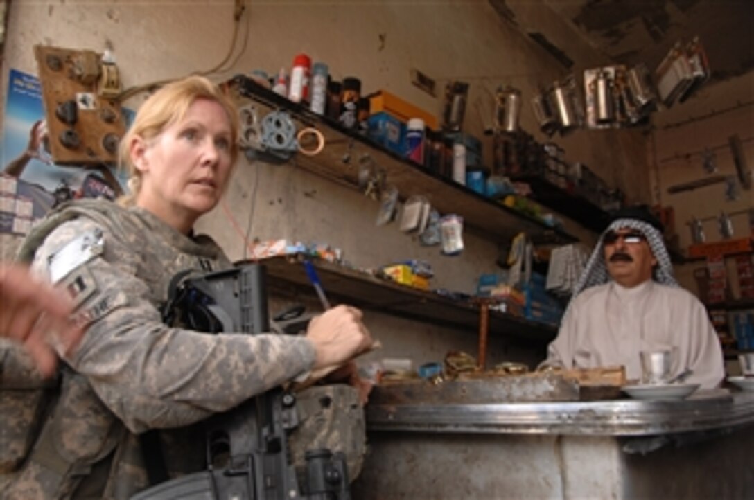 Sheik Emtyher Muja speaks to U.S. Army Capt. Jayne Strathe, of the 1314th Civil Affairs Company, attached to 17th Fires Brigade, during a foot patrol through the neighborhood of Al Hayanniah, Iraq, on Mar. 31, 2010.  The neighborhood is known as one of the roughest neighborhoods in the city of Basra.  
