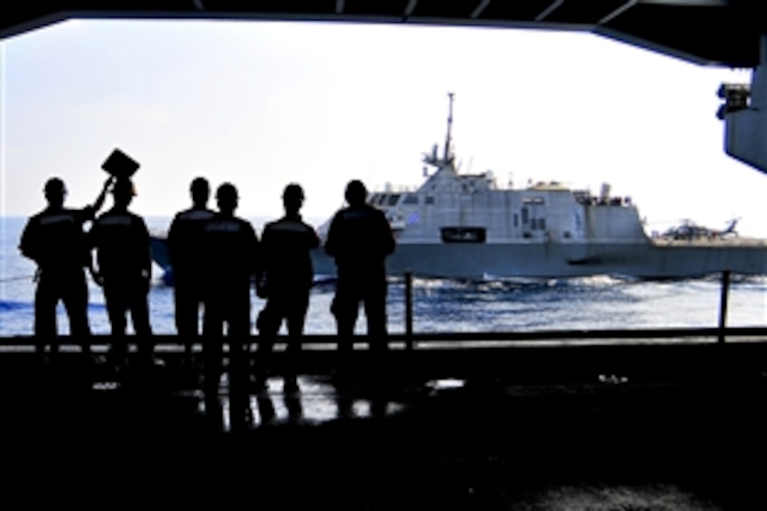 U.S. sailors watch as the combat ship USS Freedom conducts a refueling at sea with the aircraft carrier USS Carl Vinson in the Pacific Ocean, April 7, 2010. The Freedom is conducting counter-illicit trafficking operations and the Carl Vinson is supporting Southern Seas, a U.S. Southern Command-directed operation to provide U.S. and international forces the opportunity to operate in a multinational environment.