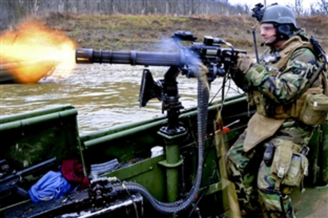 U.S. Navy Petty Officer 3rd Class Geoffrey Martin, assigned to Riverine Squadron 1, fires a GAU-17A gun from the bow of a riverine assault boat during live-fire battle drills on Fort Knox, Ky., March 28, 2010.
