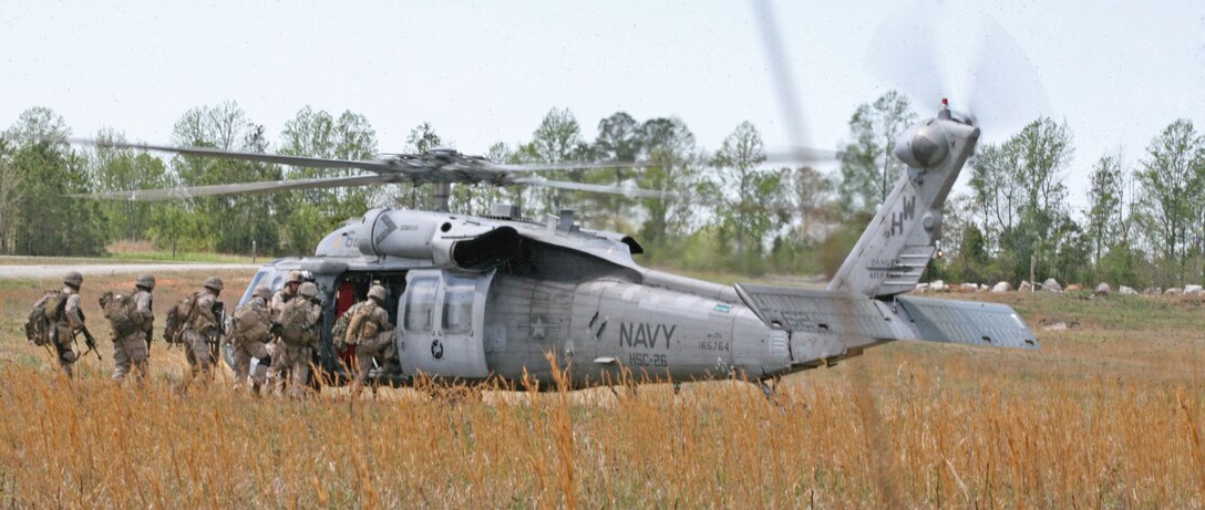 Marines from Company B, 1st Bn., 8th Marines, load onto a Navy MH-60S Knighthawk, with Helicopter Sea Combat Squadron 26, during pre-deployment training exercises in the landing zone outside the Forward Operating Base Phoenix aboard National Guard Maneuver Training Center, Fort Pickett, Va., April 9, 2010.