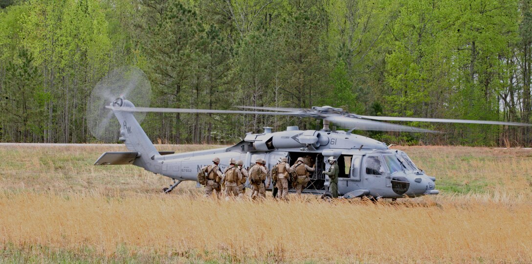 Marines from Company B, 1st Battalion, 8th Marines, load onto a Navy MH-60S Knighthawk, with Helicopter Sea Combat Squadron 26, during pre-deployment training exercises in the landing zone outside the Forward Operating Base Phoenix aboard National Guard Maneuver Training Center, Fort Pickett Va., April 9, 2010.