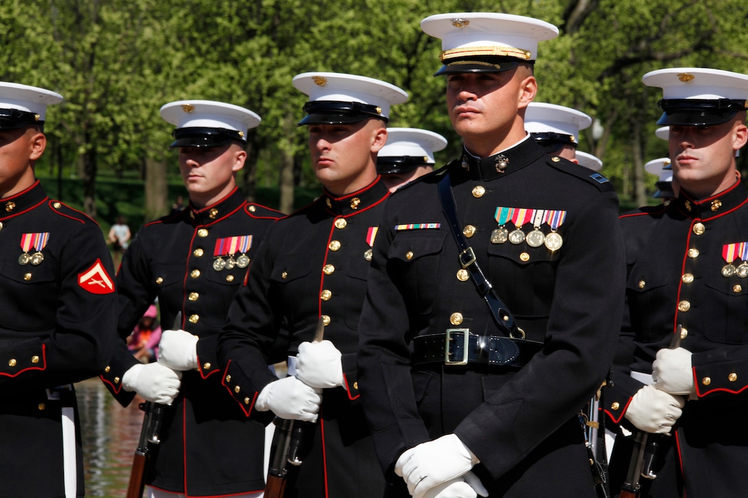 Capt. John McLaughlin, the platoon commander for the Silent Drill Platoon, Company A, Marine Barracks Washington, waits with the rest of the platoon to hear the results of the Third Annual Joint Service Drill Exhibition in Washington April 10, 2010. After careful deliberation, judges representing all five services declared the U.S. Army Drill Team the winners of the competition.