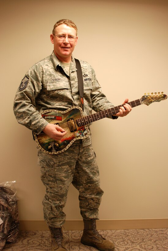 932nd Airlift Wing Master Sgt. Anthony Loving is a musician who also builds his own instruments. His favorite is the electric guitar.  "I like them jangly and loud," he said. Sergeant Loving has played in bands since high school. He can play guitar, bass and the mandolin. In fact, Sergeant Loving played the mandolin at age 12. Several years ago the senior NCO tried his hand at building an acoustic guitar and a mandolin from kits.  Here, he holds his latest six string creation.  (U.S. Air Force photo/Tech Sgt. Dan Oliver)