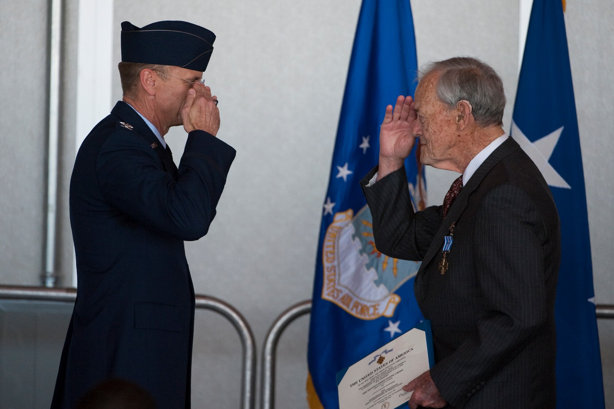HOLLOMAN AIR FORCE BASE, N.M. -- Col. Donald Lindberg, 44th Fighter Group commander, presents the Distinguished Flying Cross April 9, 2010, to Retired Capt. Arthur Kleiderer for distinguished service as group lead pilot for the 44th Bomb Group during 14 combat missions near the conclusion of World War II. The 44th Fighter Group traces its lineage to the famed World War II 44th Bombardment Group (Heavy) originally activated in January 1941 at MacDill Army Air Field in Tampa, Fla., and flew the then state of the art B-24 Liberator. Sixty-nine years later, the 44th Fighter Group is the only Air Force Reserve organization to be selected to fly the U.S. Air Force's premier air superiority fighter, the F-22 Raptor. (U.S. Air Force photo by Staff Sgt. Joe Laws / Released)
