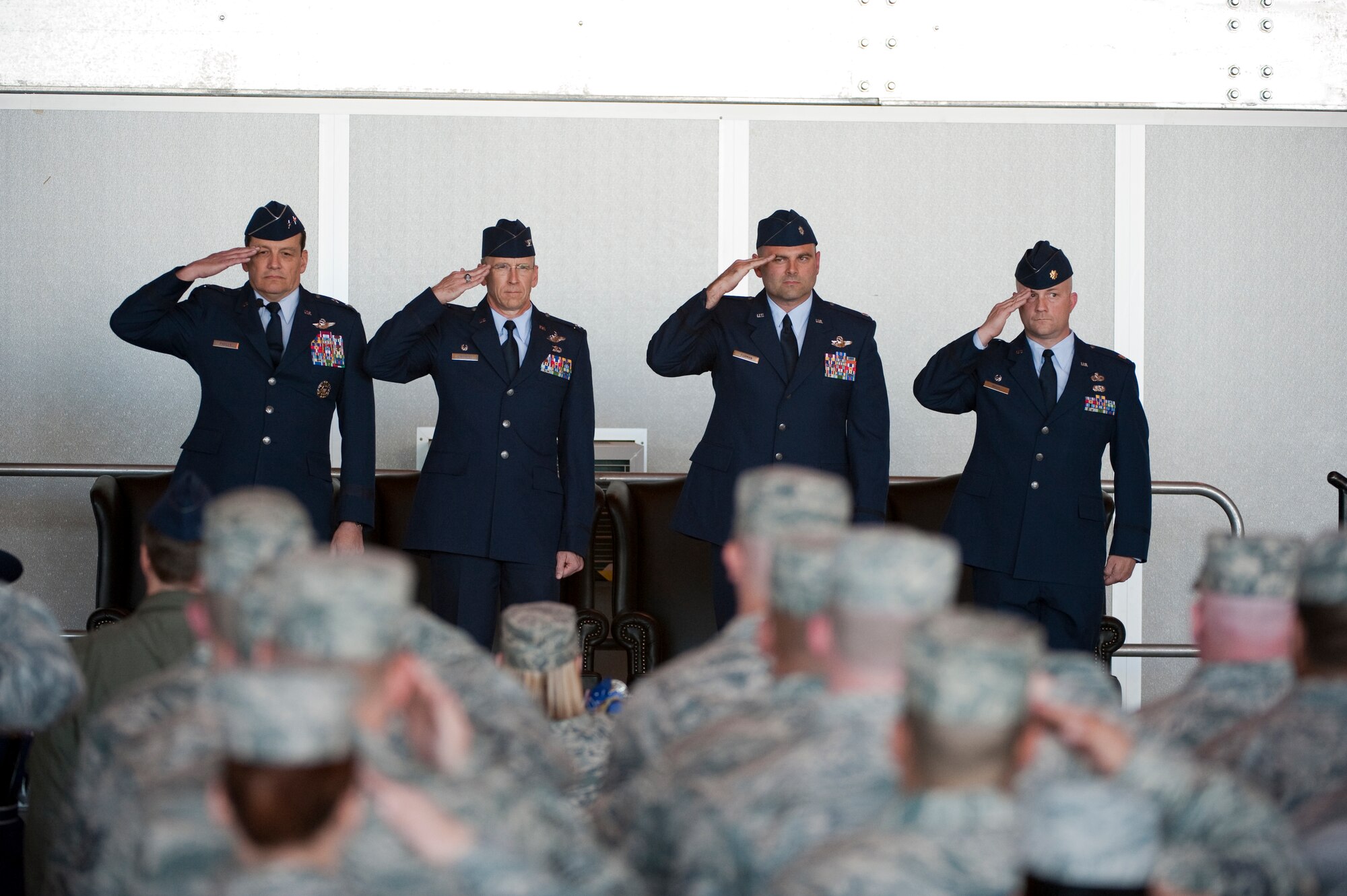 HOLLOMAN AIR FORCE BASE, N.M. -- U.S. Air force members stand and salute during the national anthem during the 44th Fighter Group Activation ceremony April 9, 2010. The 44th Fighter Group traces its lineage to the famed World War II 44th Bombardment Group (Heavy) originally activated in January 1941 at MacDill Army Air Field in Tampa, Fla., and flew the then state of the art B-24 Liberator. Sixty-nine years later, the 44th Fighter Group is the only Air Force Reserve organization to be selected to fly the U.S. Air Force's premier air superiority fighter, the F-22 Raptor. (U.S. Air Force photo by Staff Sgt. Joe Laws / Released)