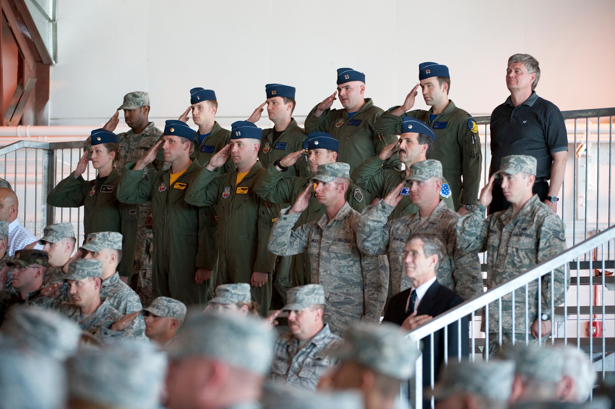 HOLLOMAN AIR FORCE BASE, N.M. -- U.S. Air force members stand and salute during the national anthem during the 44th Fighter Group Activation ceremony  April 9, 2010. The 44th Fighter Group traces its lineage to the famed World War II 44th Bombardment Group (Heavy) originally activated in January 1941 at MacDill Army Air Field in Tampa, Fla., and flew the then state of the art B-24 Liberator. Sixty-nine years later, the 44th Fighter Group is the only Air Force Reserve organization to be selected to fly the U.S. Air Force's premier air superiority fighter, the F-22 Raptor. (U.S. Air Force photo by Staff Sgt. Joe Laws / Released)