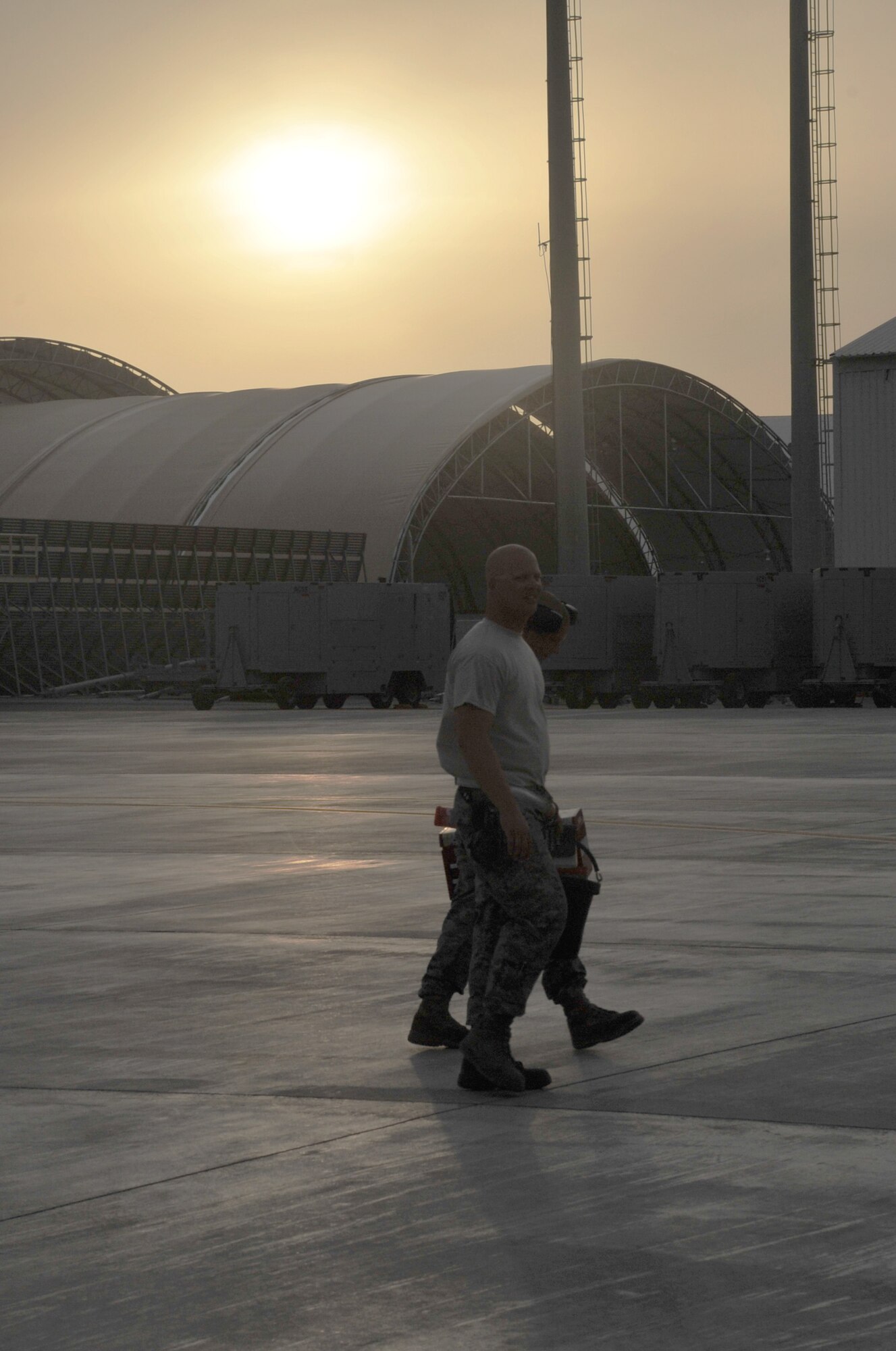 Maintenance Airmen from the 380th Expeditionary Aircraft Maintenance Squadron carry their toolboxes across the flightline after completing some work during operations for the 380th Air Expeditionary Wing at a non-disclosed base in Southwest Asia on April 9, 2010.  The 380th EAMXS, as part of the 380th AEW, supports operations Iraqi Freedom and Enduring Freedom and the Combined Joint Task Force-Horn of Africa. The 380th AEW is home to the o the KC-10 Extender, U-2 Dragon Lady, E-3 Sentry and RQ-4 Global Hawk aircraft. Maintenance Airmen who work on all four airframes make up the 380th EAMXS. (U.S. Air Force Photo/Master Sgt. Scott T. Sturkol/Released)