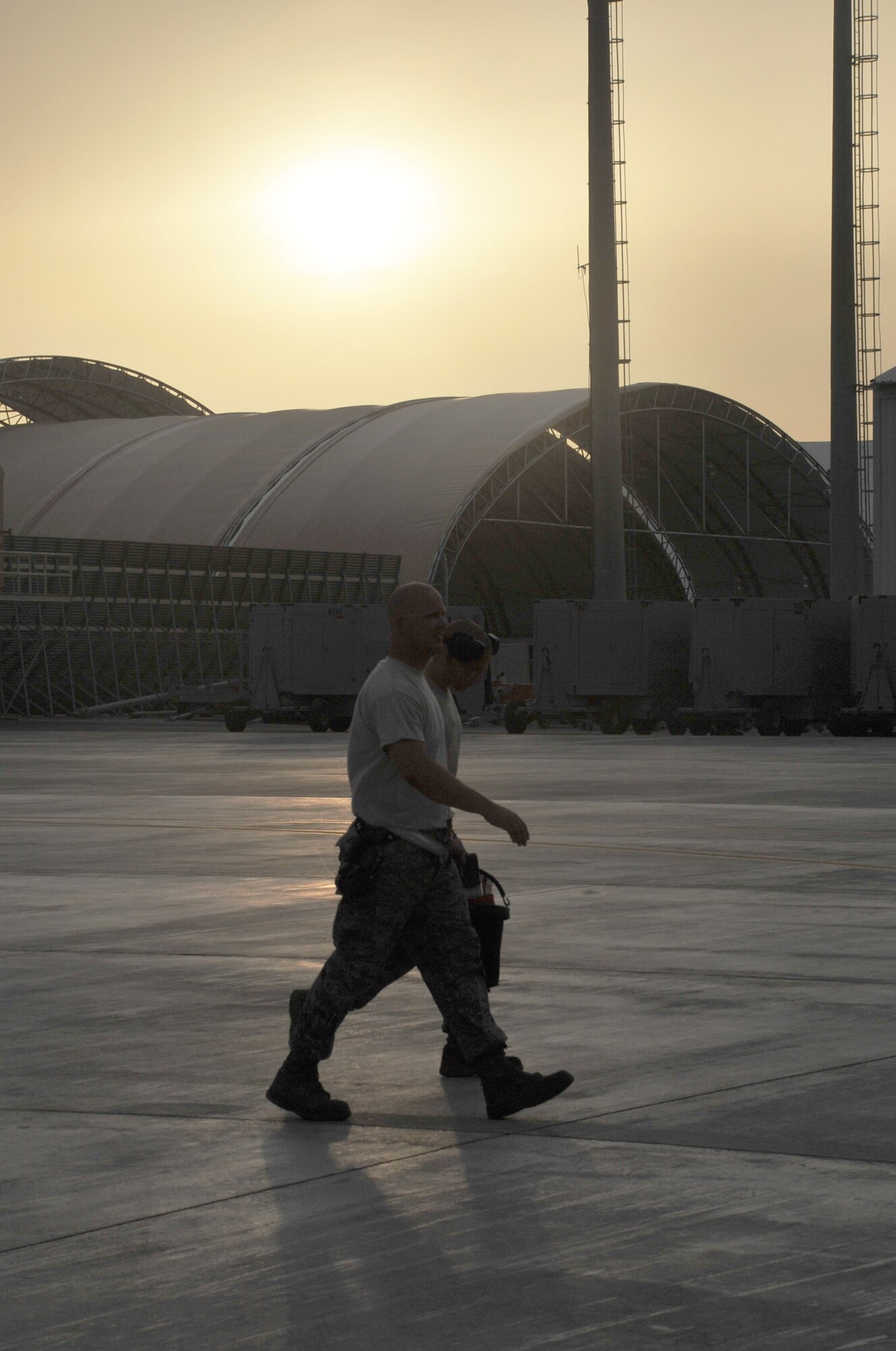 Maintenance Airmen from the 380th Expeditionary Aircraft Maintenance Squadron carry their toolboxes across the flightline after completing some work during operations for the 380th Air Expeditionary Wing at a non-disclosed base in Southwest Asia on April 9, 2010.  The 380th EAMXS, as part of the 380th AEW, supports operations Iraqi Freedom and Enduring Freedom and the Combined Joint Task Force-Horn of Africa. The 380th AEW is home to the o the KC-10 Extender, U-2 Dragon Lady, E-3 Sentry and RQ-4 Global Hawk aircraft. Maintenance Airmen who work on all four airframes make up the 380th EAMXS. (U.S. Air Force Photo/Master Sgt. Scott T. Sturkol/Released)