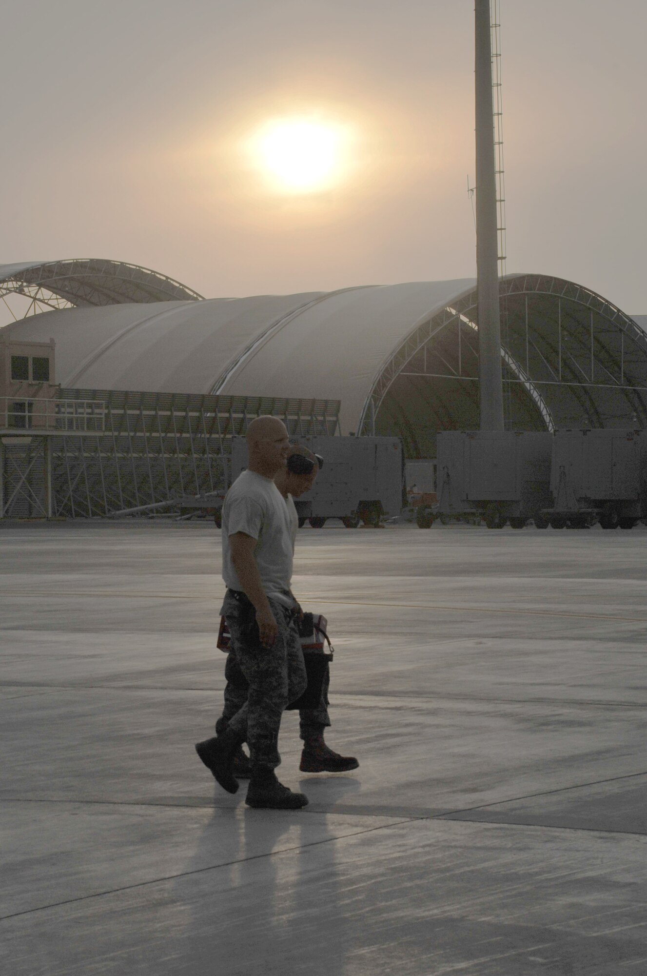 Maintenance Airmen from the 380th Expeditionary Aircraft Maintenance Squadron carry their toolboxes across the flightline after completing some work during operations for the 380th Air Expeditionary Wing at a non-disclosed base in Southwest Asia on April 9, 2010.  The 380th EAMXS, as part of the 380th AEW, supports operations Iraqi Freedom and Enduring Freedom and the Combined Joint Task Force-Horn of Africa. The 380th AEW is home to the o the KC-10 Extender, U-2 Dragon Lady, E-3 Sentry and RQ-4 Global Hawk aircraft. Maintenance Airmen who work on all four airframes make up the 380th EAMXS. (U.S. Air Force Photo/Master Sgt. Scott T. Sturkol/Released)
