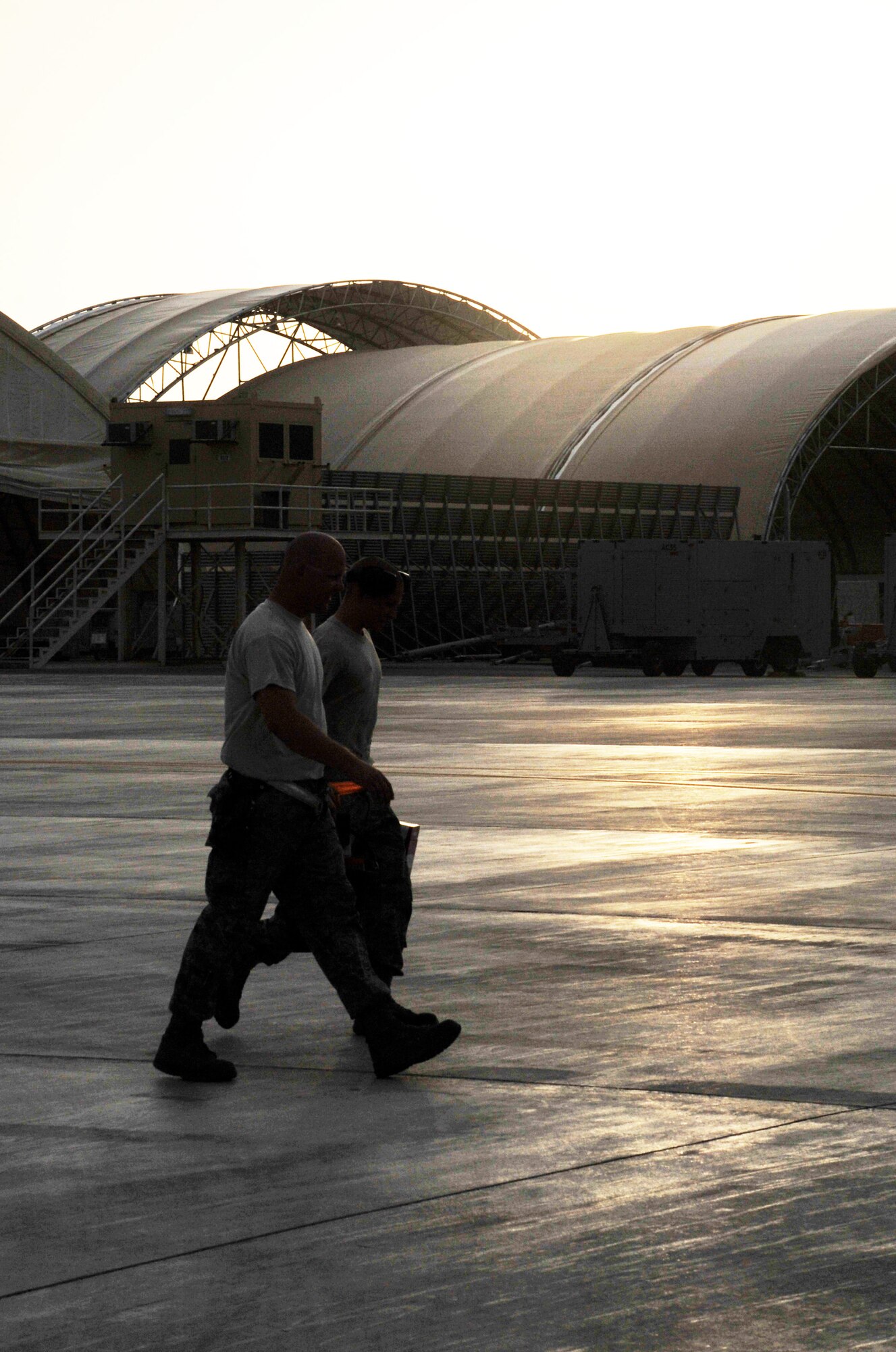 Maintenance Airmen from the 380th Expeditionary Aircraft Maintenance Squadron carry their toolboxes across the flightline after completing some work during operations for the 380th Air Expeditionary Wing at a non-disclosed base in Southwest Asia on April 9, 2010.  The 380th EAMXS, as part of the 380th AEW, supports operations Iraqi Freedom and Enduring Freedom and the Combined Joint Task Force-Horn of Africa. The 380th AEW is home to the o the KC-10 Extender, U-2 Dragon Lady, E-3 Sentry and RQ-4 Global Hawk aircraft. Maintenance Airmen who work on all four airframes make up the 380th EAMXS. (U.S. Air Force Photo/Master Sgt. Scott T. Sturkol/Released)