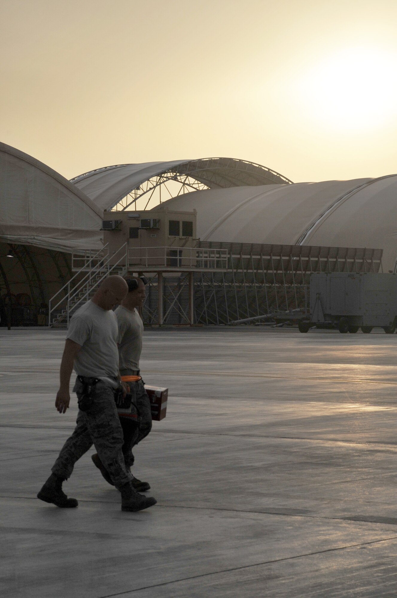 Maintenance Airmen from the 380th Expeditionary Aircraft Maintenance Squadron carry their toolboxes across the flightline after completing some work during operations for the 380th Air Expeditionary Wing at a non-disclosed base in Southwest Asia on April 9, 2010.  The 380th EAMXS, as part of the 380th AEW, supports operations Iraqi Freedom and Enduring Freedom and the Combined Joint Task Force-Horn of Africa. The 380th AEW is home to the o the KC-10 Extender, U-2 Dragon Lady, E-3 Sentry and RQ-4 Global Hawk aircraft. Maintenance Airmen who work on all four airframes make up the 380th EAMXS. (U.S. Air Force Photo/Master Sgt. Scott T. Sturkol/Released)