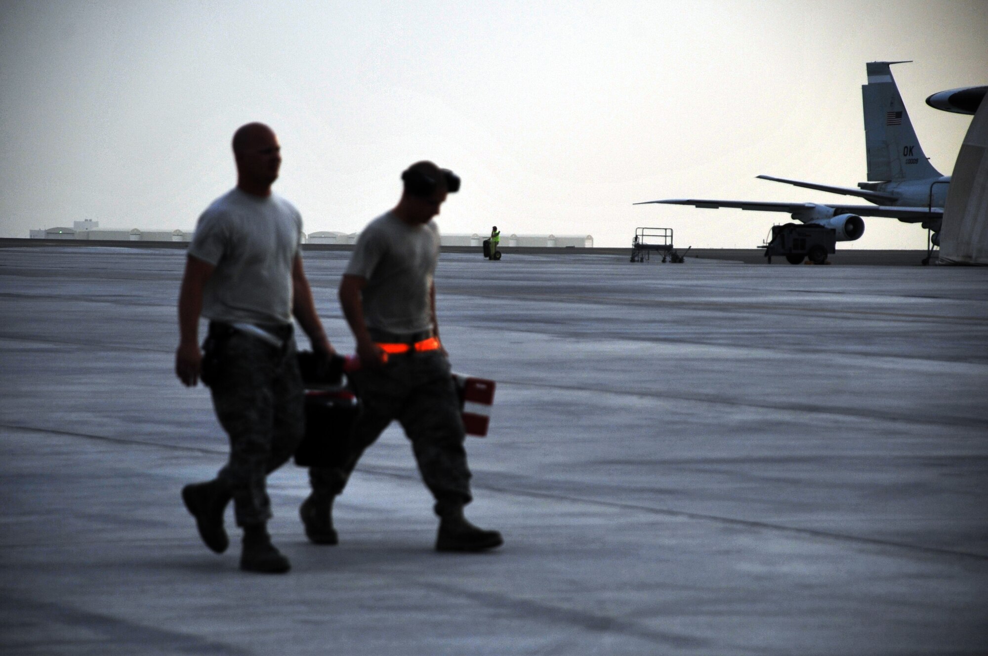 Maintenance Airmen from the 380th Expeditionary Aircraft Maintenance Squadron carry their toolboxes across the flightline after completing some work during operations for the 380th Air Expeditionary Wing at a non-disclosed base in Southwest Asia on April 9, 2010.  The 380th EAMXS, as part of the 380th AEW, supports operations Iraqi Freedom and Enduring Freedom and the Combined Joint Task Force-Horn of Africa. The 380th AEW is home to the o the KC-10 Extender, U-2 Dragon Lady, E-3 Sentry and RQ-4 Global Hawk aircraft. Maintenance Airmen who work on all four airframes make up the 380th EAMXS. (U.S. Air Force Photo/Master Sgt. Scott T. Sturkol/Released)