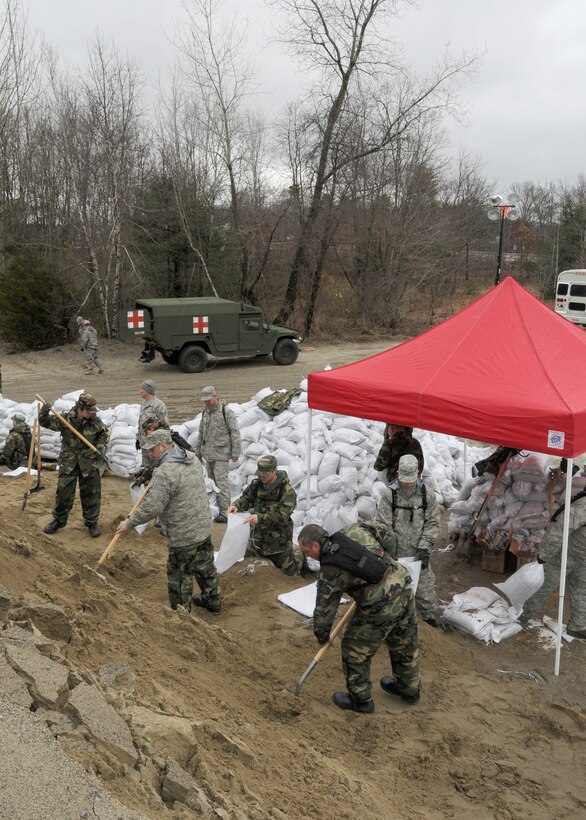 Members of the 104th Fighter Wing, Massachusetts Air National Guard, activated in support of Operation RISING WATER, fill thousands of sandbags on March 31, 2010 to be used in impacted areas threatened by flooding during recent rain storms.
