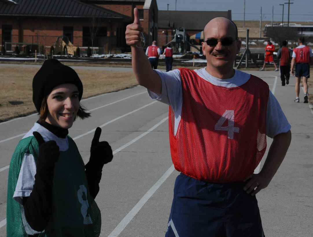 Several members of the 932nd Airlift Wing finish up the 1.5 mile run with a smile and a thumbs up signal.  "It's all about attitude and making the effort fun," said one participant.  The unit stresses physical fitness throughout the year and holds practice sessions on Saturday afternoons at the base track.  (U.S. Air Force photo/Maj. Stan Paregien)
