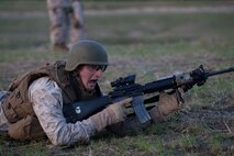 A Marine from  2nd Battalion, 25th Marine Regiment, 4th Marine Division, Marine Forces Reserve, shouts commands to his Marines as they advance through a live-fire course in Quantico, Va., April 10.