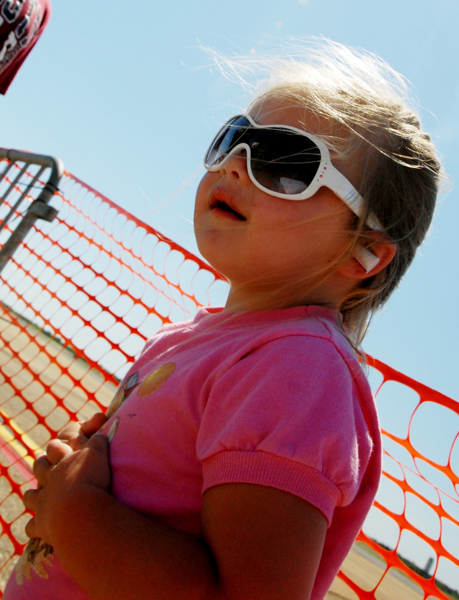 EGLIN AIR FORCE BASE, Fla. -- Three-year-old Gabbrielle Jorgensen waits for another Thunderbird F-16 pass during a practice show April 9 here. The weekend airshow drew more than 70,000 people each day. The T-birds headlined the show. (U.S. Air Force photo/Samuel King Jr.)