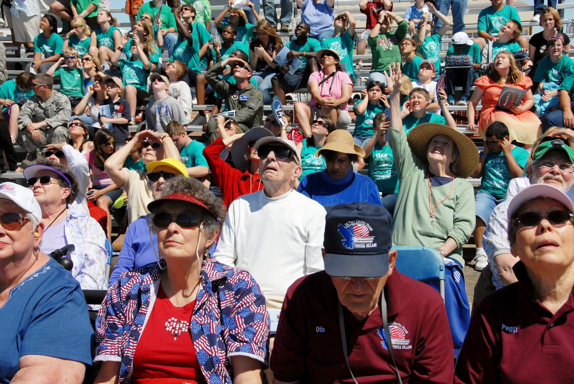 EGLIN AIR FORCE BASE, Fla. -- The crowd stares up as the Thunderbird F-16s roar overhead April 9 here.  The weekend airshow drew more than 70,000 people each day.  The T-birds headlined the show.  (U.S. Air Force photo/Samuel King Jr.)