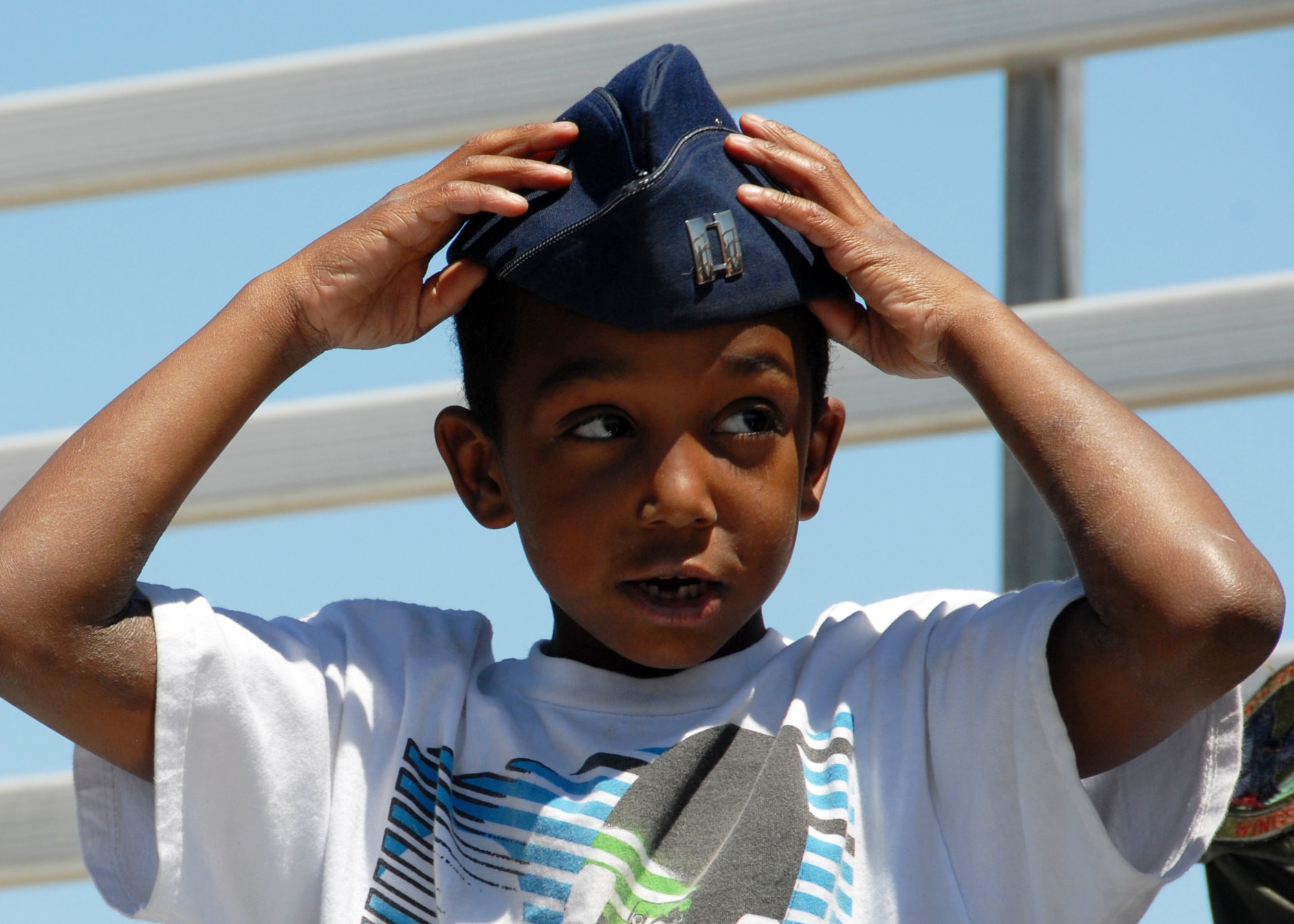 EGLIN AIR FORCE BASE, Fla. -- A new Air Force recruit tries the flight cap on for size while waiting for the Thunderbirds show April 9 here. The weekend airshow drew more than 70,000 people each day.  The T-birds headlined the show.  (U.S. Air Force photo/Samuel King Jr.)