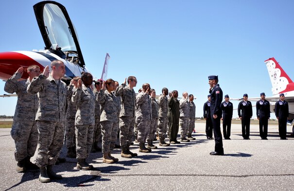 EGLIN AIR FORCE BASE, Fla. -- Nineteen Airmen from Eglin Air Force Base and Hurlburt Field take the oath of enlistment from the commander of the Air Force Thunderbirds April 9 prior to their practice show on base.  The Eglin airshow drew more than 70,000 people each day April 10,11.  The T-birds headlined the show.  (U.S. Air Force photo/Samuel King Jr.)