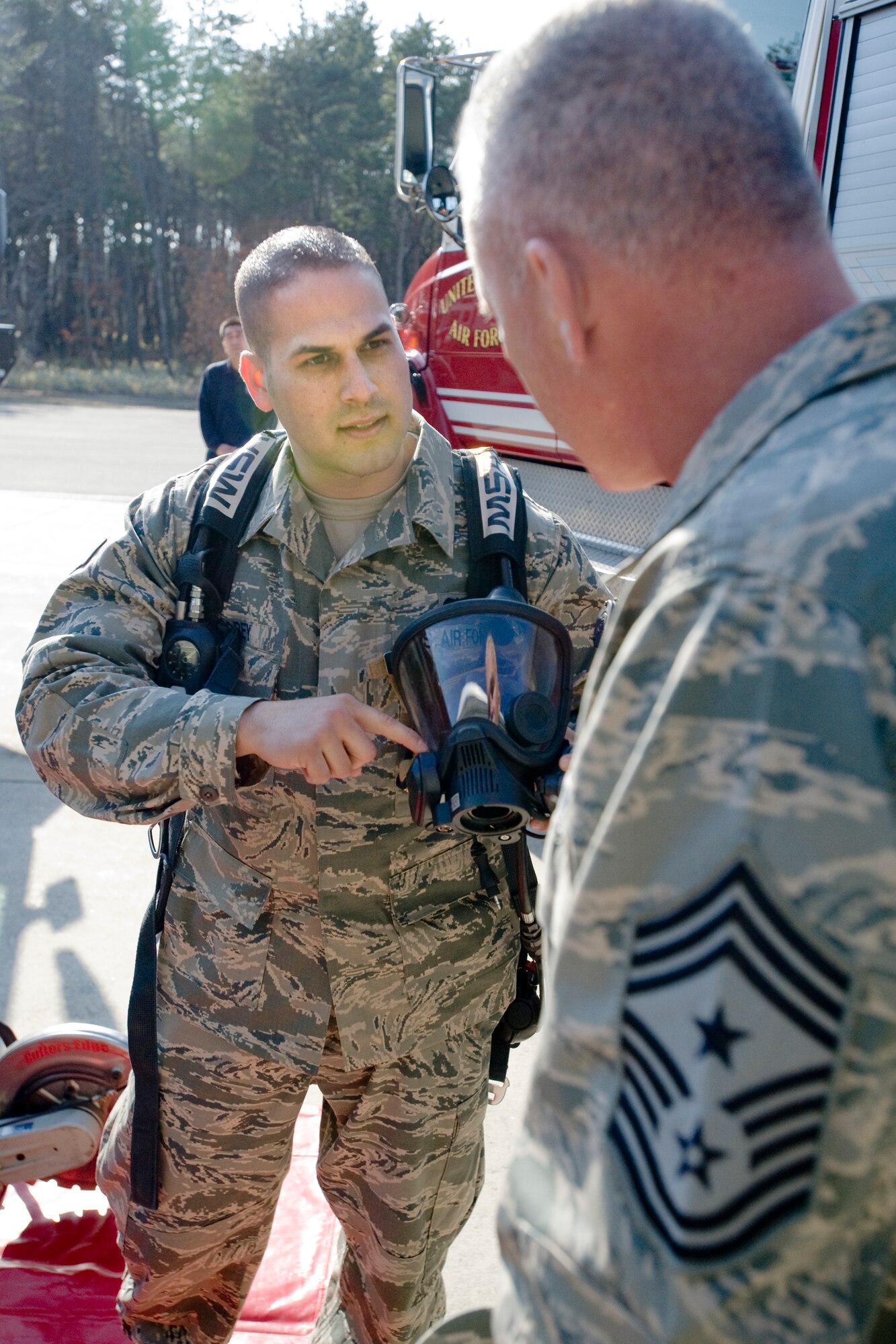 MISAWA AIR BASE, Japan -- Senior Airman Christopher Carey, 35th Civil Engineer Squadron driver operator, shows specifications of an MSA Firehawk Air Pack to Chief Master Sgt. Brooke McLean, Pacific Air Forces command chief master sergeant, April 8 at Fire Station Number One. Airman Carey explained that the air pack is the latest in self-contained breathing apparatus gear used by military and civilian fire departments. (U.S. Air Force photo/Senior Airman Jamal D. Sutter)