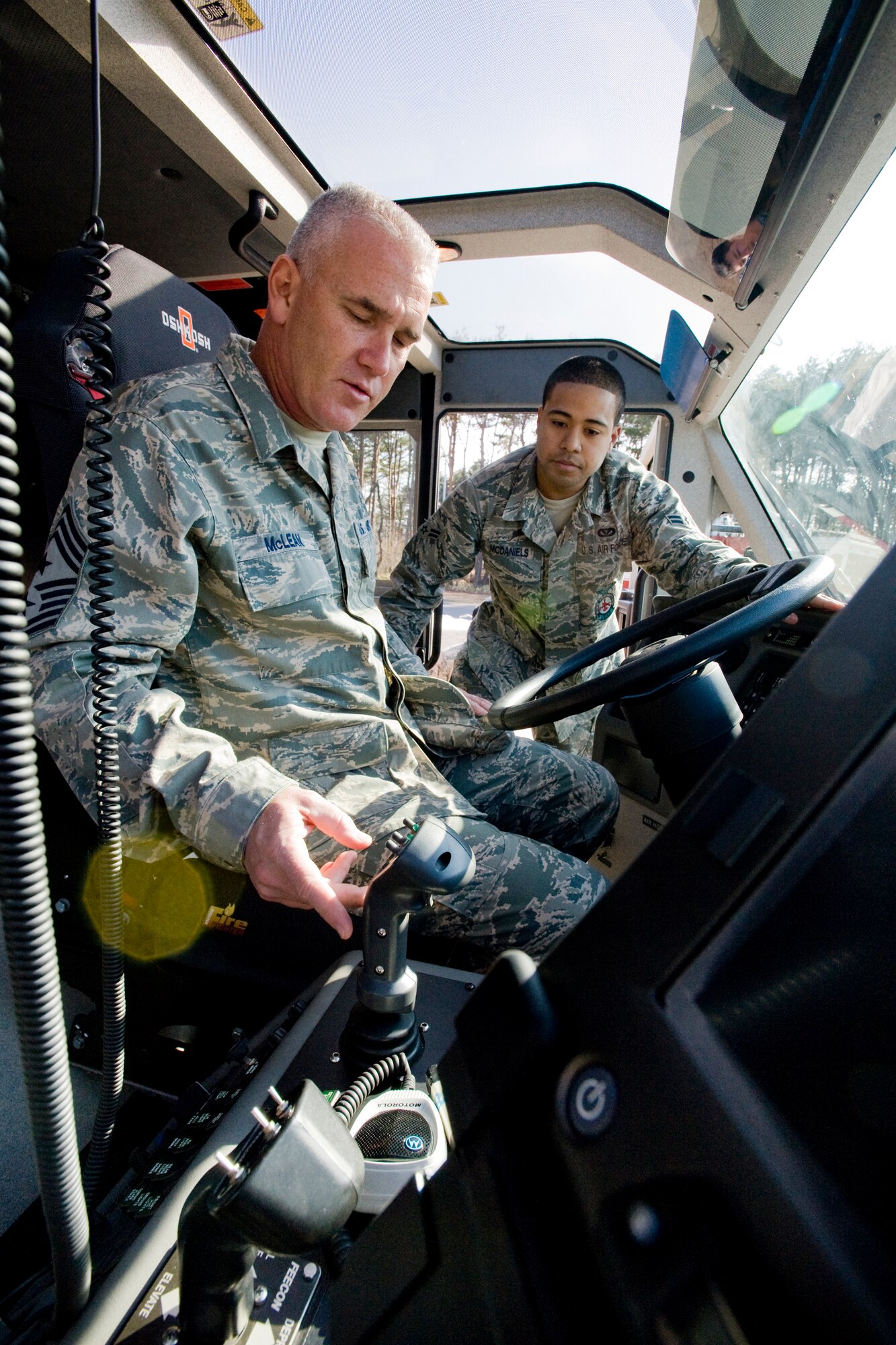 MISAWA AIR BASE, Japan -- With assistance from Airman 1st Class Jessie McDaniels, 35th Civil Engineer Squadron fire fighter, Chief Master Sgt. Brooke McLean, Pacific Air Forces command chief master sergeant, checks out specifications of an Oshkosh Striker 1500 fire truck April 8 at Fire Station Number One. Chief McLean visited to guest speak at a recent Airman Leadership School graduation and tour various units on base. (U.S. Air Force photo/Senior Airman Jamal D. Sutter)