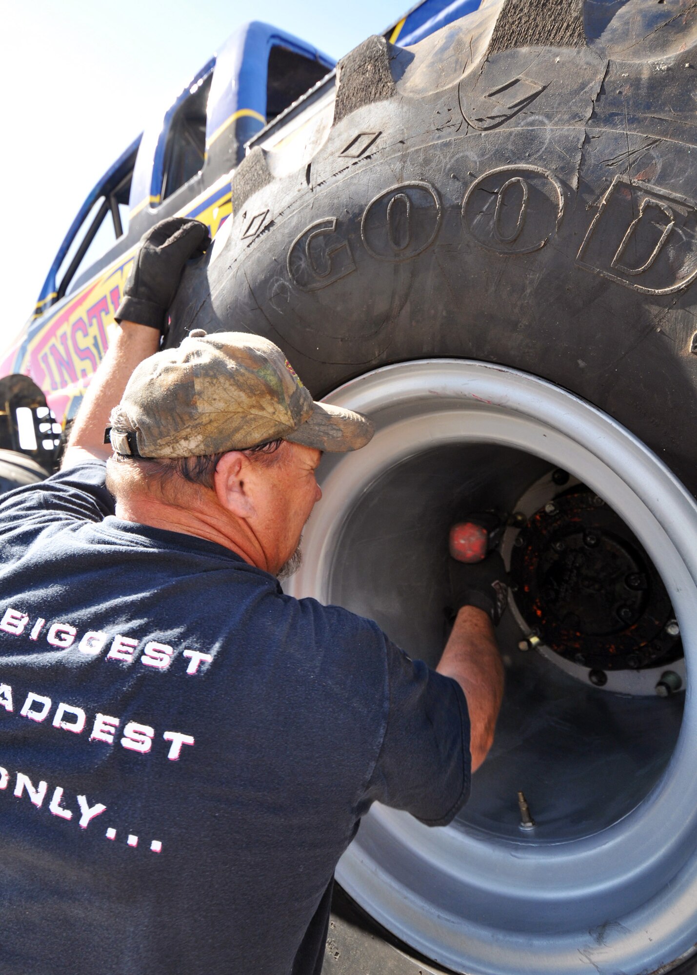 Lionel Easler tightens down the lugs on "monster" tires of his truck "The Instigator," April 9 in preparation for the weekend airshow at Eglin Air Force Base, Fla.  The truck was on display with the Air Force Reserve recruiting booth.  Mr. Easler has been driving monster trucks for five years and competes in about 35 truck shows a year.  This was the first airshow however for the Florida native.  (U.S. Air Force photo/Tech. Sgt. Samuel King Jr.)(U.S. Air Force photo/Tech. Sgt. Samuel King Jr.)